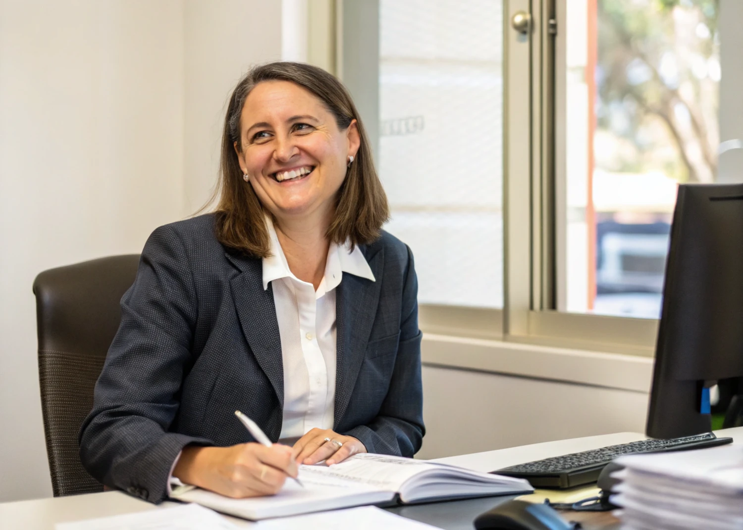 Lawyer in Melbourne, Australia, working at her desk, representing legal services and expertise